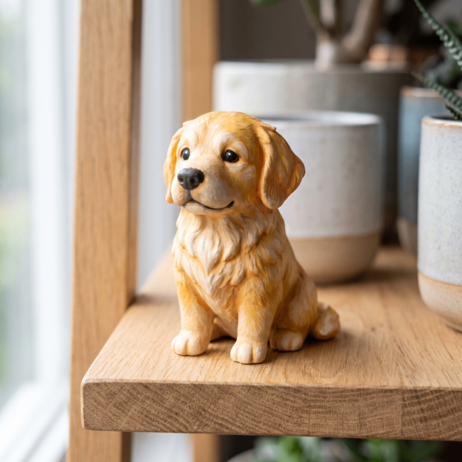 Hand-painted golden retriever figurine on a windowsill
